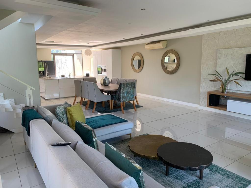 a living room with a couch and a table at Corals 4, Zimbali Estate by Euphoric Leisure in Ballito