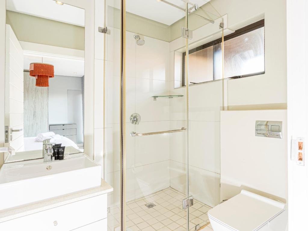 a bathroom with a shower and a toilet at Corals 4, Zimbali Estate by Euphoric Leisure in Ballito