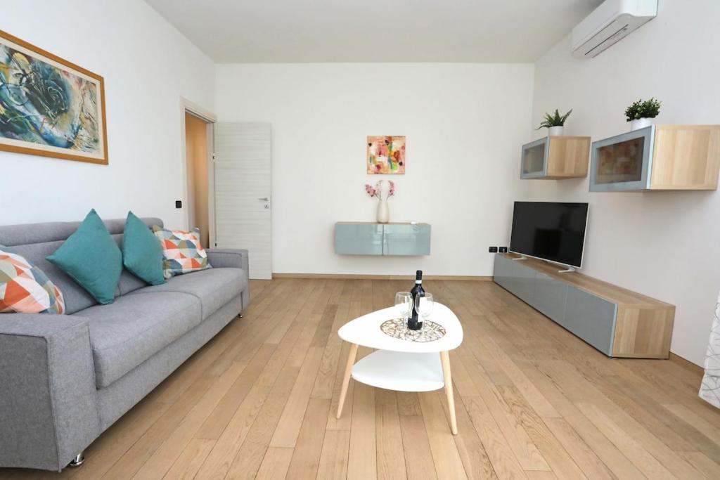 a living room with a couch and a table at Sunshine Apartment in Florence in Sesto Fiorentino