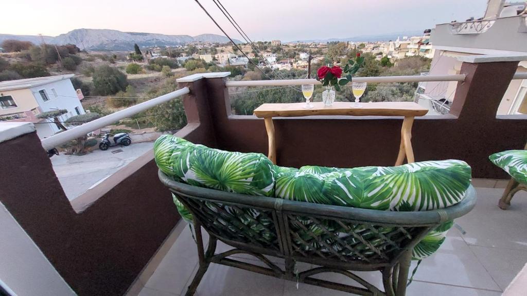 a chair sitting on a balcony with a table at The Mastiha Spot 1 in Chios