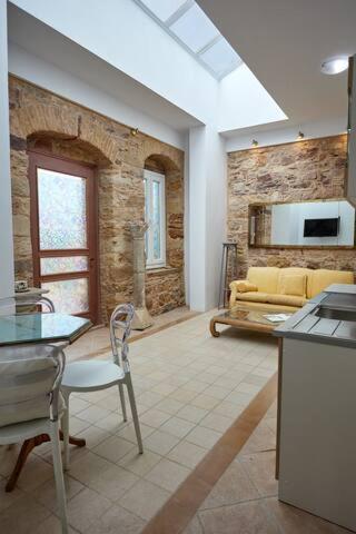 a living room with a couch and a table at Kampos Mansion 1 in Chios