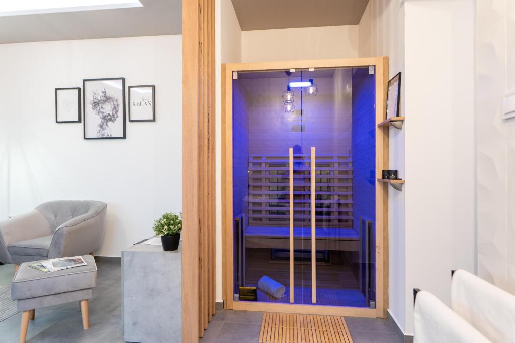 a glass door leading into a living room at AApartman Wellness - Privát Spa élmény - Bor bekészítéssel in Pécs