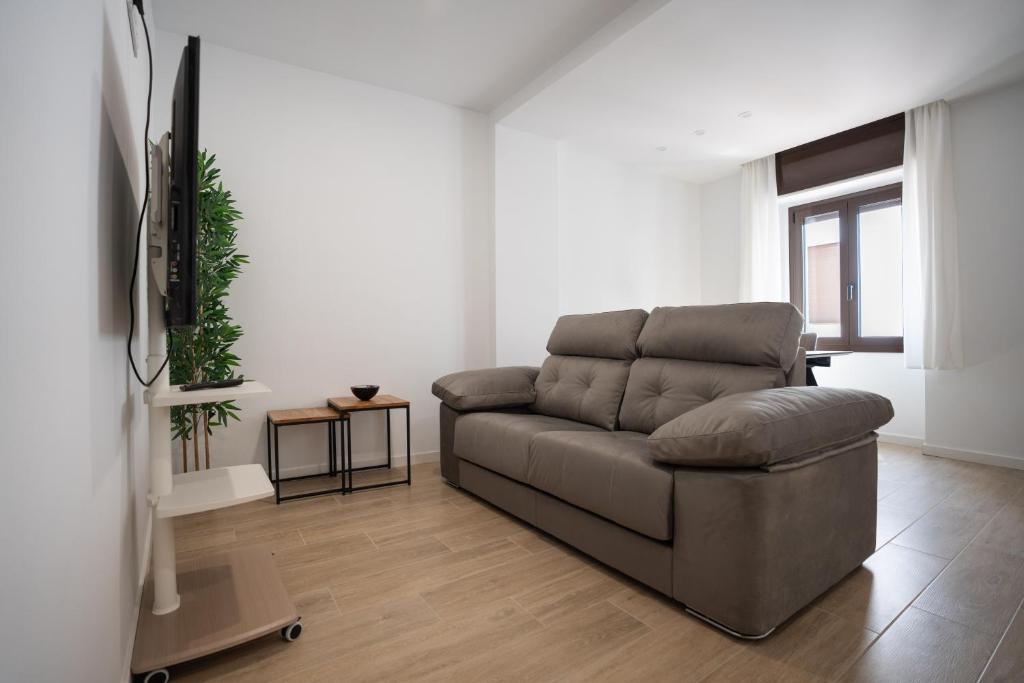 a living room with a couch and a tv at LETS HOLIDAYS Centric & Near the Sea Victoria apartment 3 in Tossa de Mar
