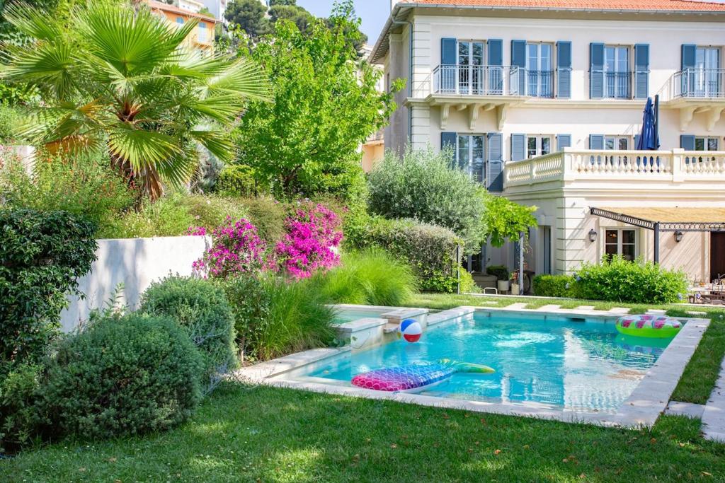a swimming pool in the yard of a house at S2 House for 12p swimming pool AC BBQ 10mins from Sea in Nice
