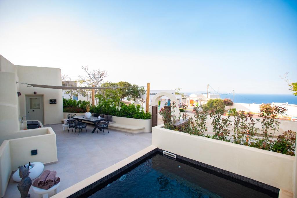 a villa with a swimming pool and a view of the ocean at Iama Luxury Suite Santorini in Imerovigli