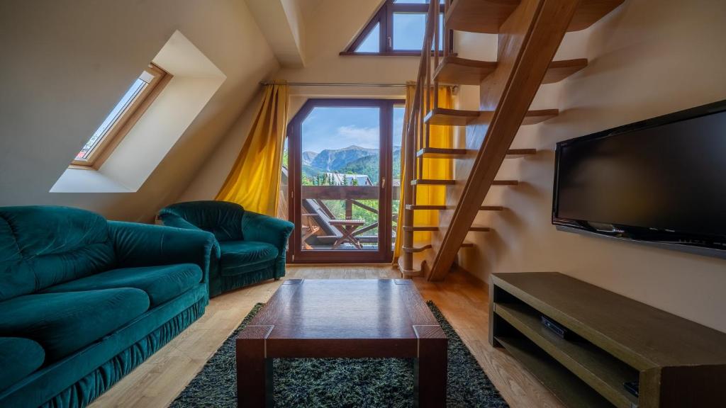 Televízia a/alebo spoločenská miestnosť v ubytovaní Apartamenty Sun & Snow Kościelisko Chotarz z basenem