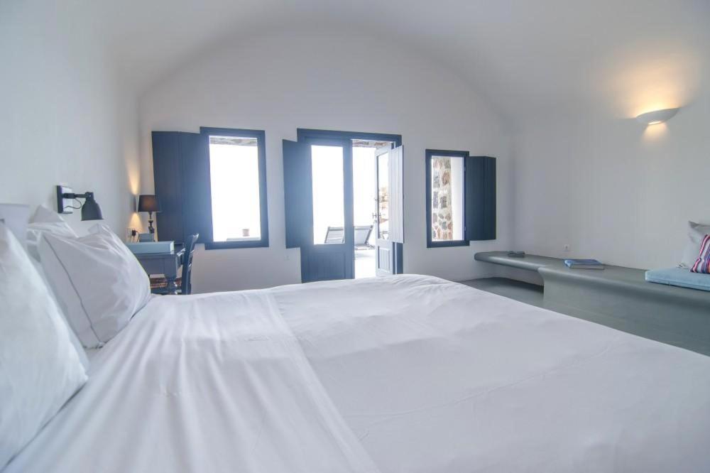 Postel nebo postele na pokoji v ubytování Grand Ambassador Santorini Hotel