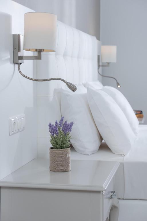 Postel nebo postele na pokoji v ubytování Dore Boutique Hotel