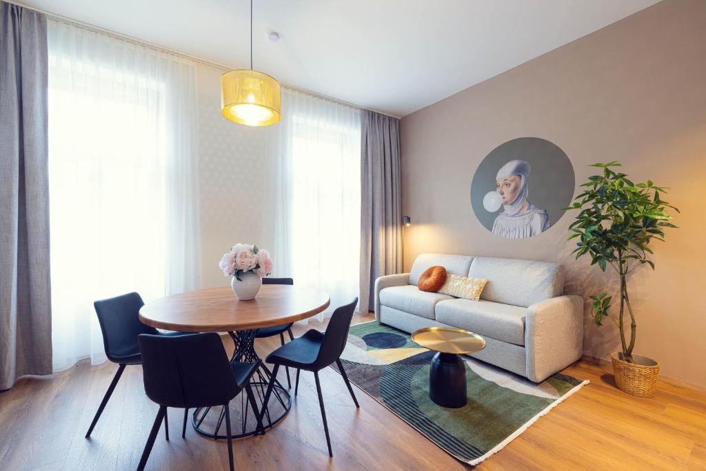 a living room with a couch and a table at LeonArt Living 34 in Graz