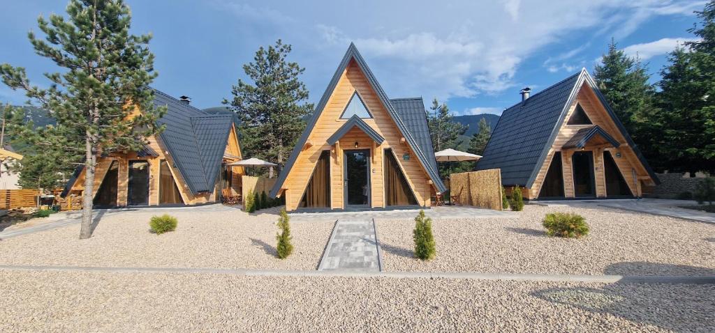 a wooden church with a pointed roof at LandHaus Tri Vikendice in Risovac