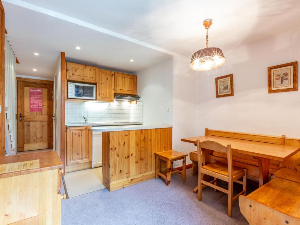 Il comprend une cuisine et une salle à manger avec une table en bois. dans l'établissement Duplex charmant près du centre et des pistes, avec balcon sud, parking et wifi inclus - FR-1-694-39, à Val dʼIsère