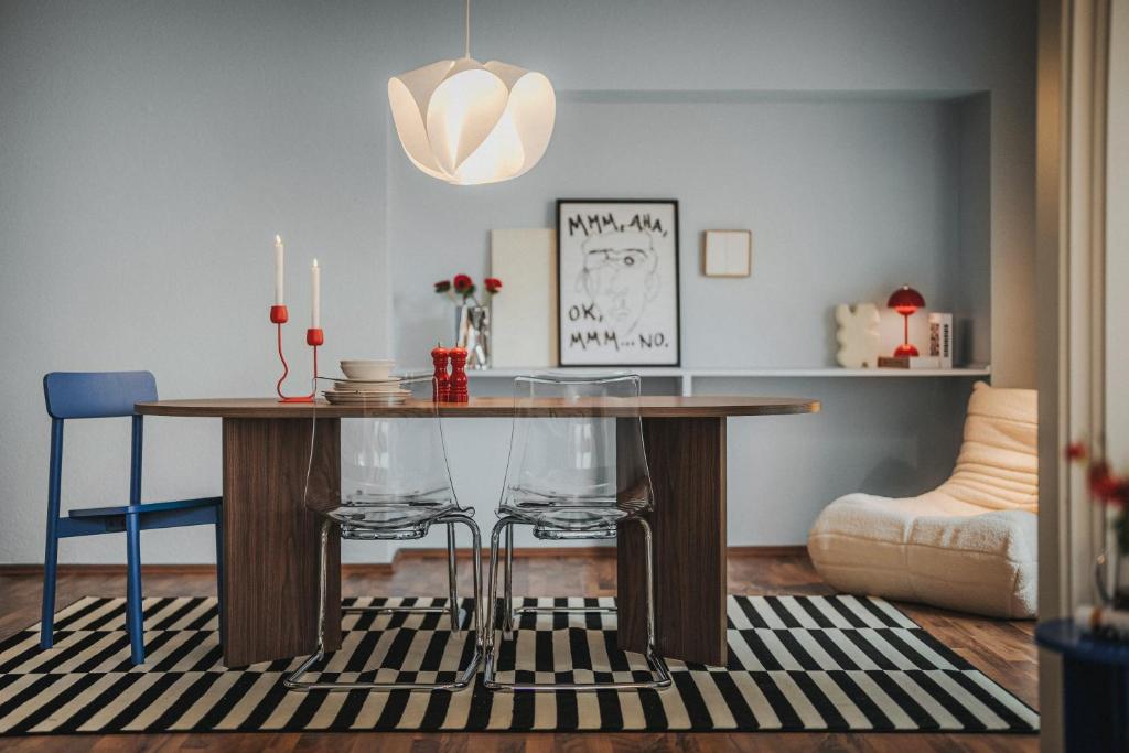 奥尔登堡LINDEN Apartment für bis zu 6 Personen mit Parkplatz, Terrasse, 2 Bäder und Babybett的有一张桌子和两把椅子的餐厅