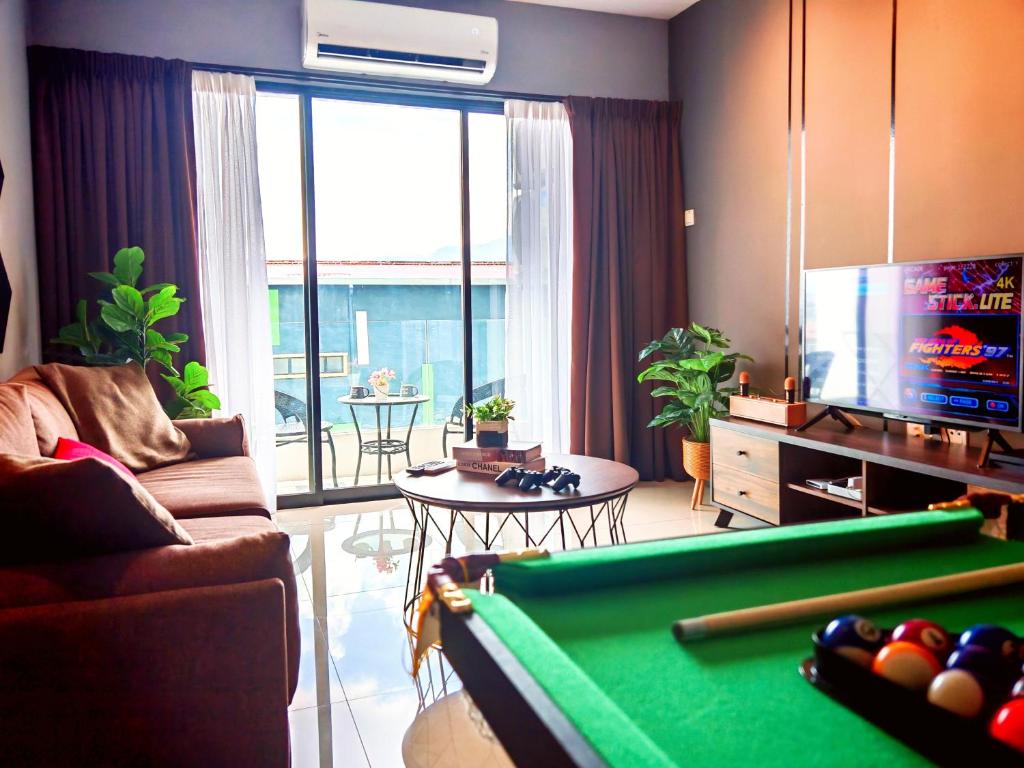 a living room with a pool table and a television at Ipoh Manhattan Waterpark 3BR Suite by City Home Empire MHB509 in Ipoh