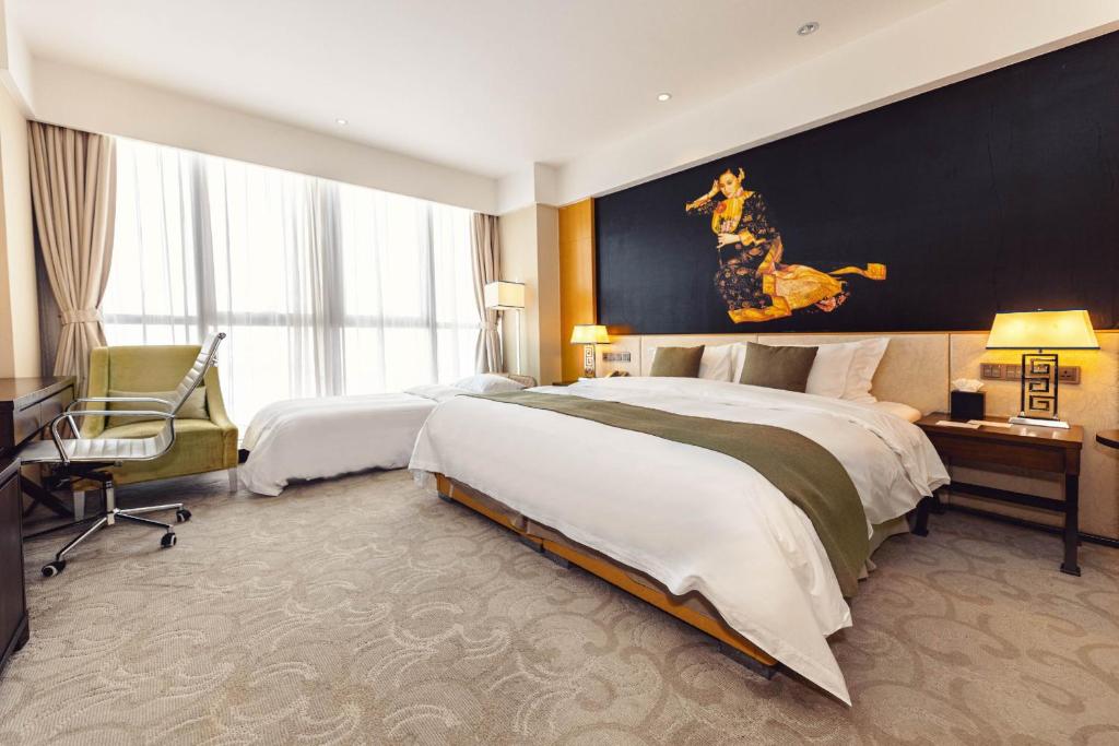Postel nebo postele na pokoji v ubytování Hotels & Preference Hualing Tbilisi
