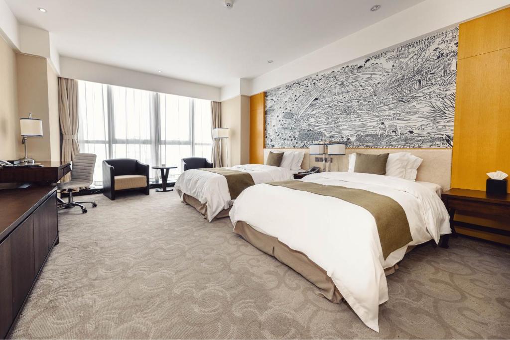 Postel nebo postele na pokoji v ubytování Hotels & Preference Hualing Tbilisi