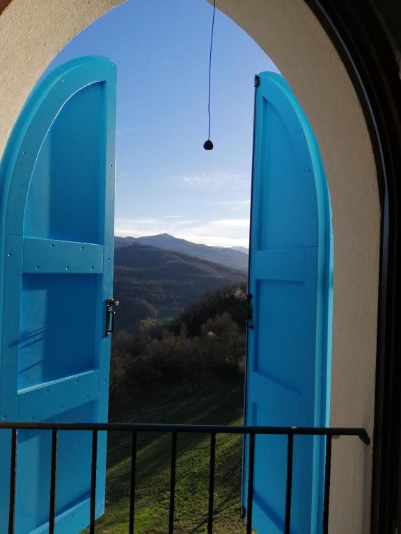 an open door to a balcony with a view at That's amore - l'incanto della valle in Monchio