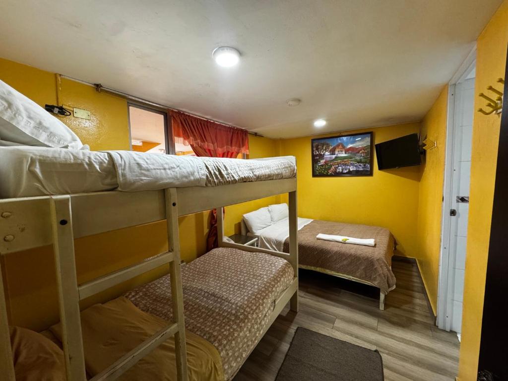 Postel nebo postele na pokoji v ubytování Hotel Jimmy Latacunga