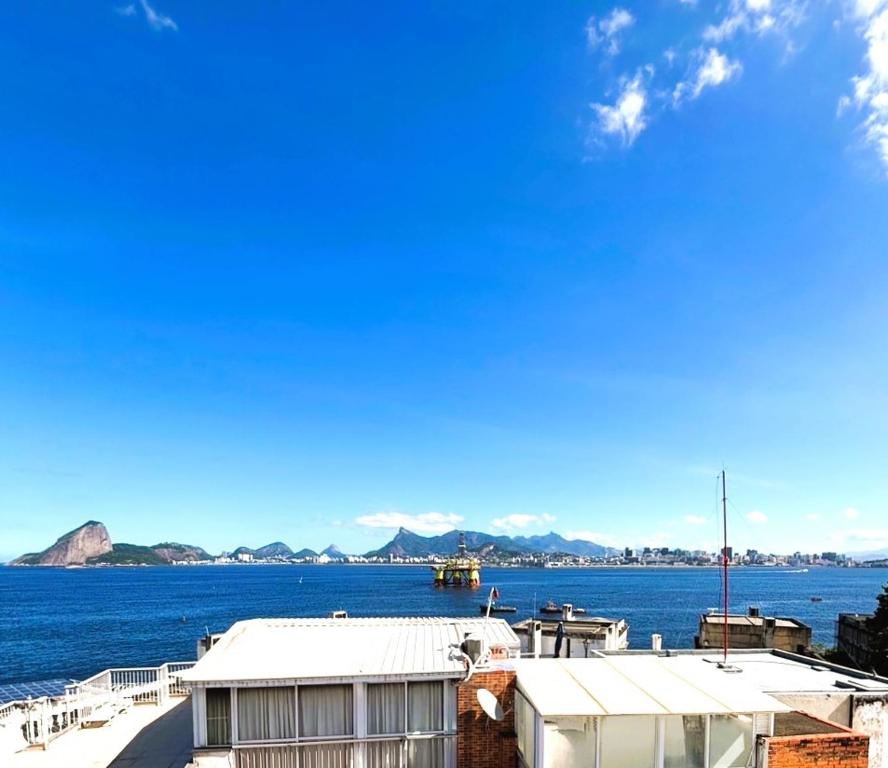 a view of a body of water with a building at UniHome Niterói by Housi in Niterói