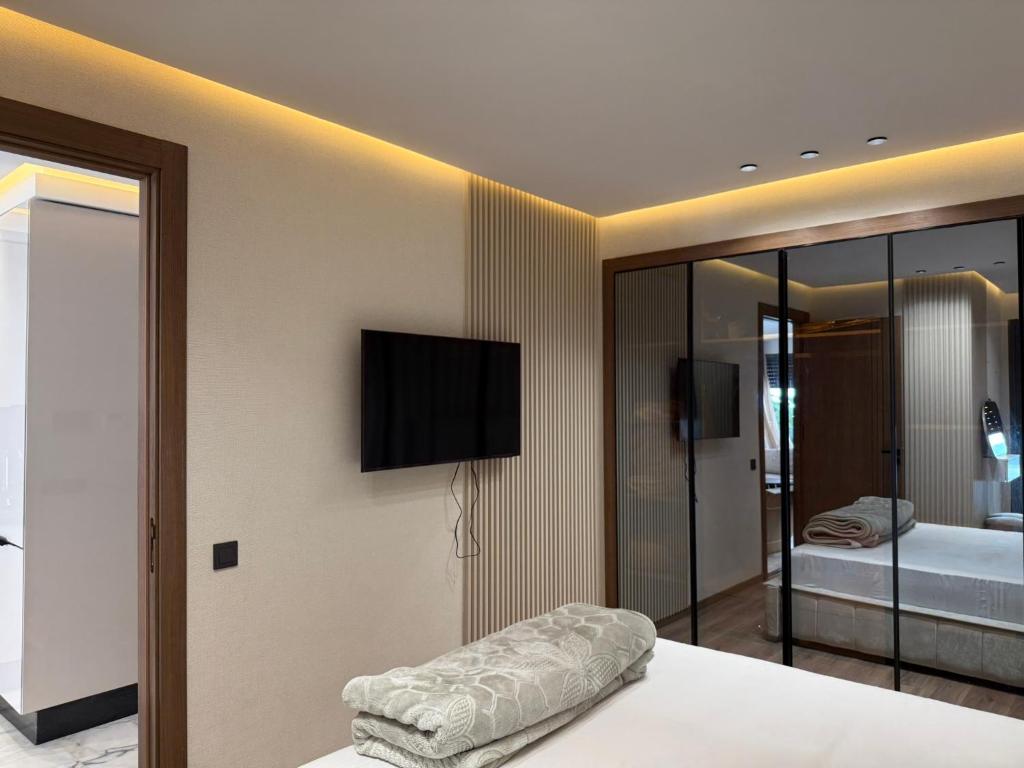 a bedroom with a bed with a television on the wall at Joli Studio with Seaview 16 in Casablanca