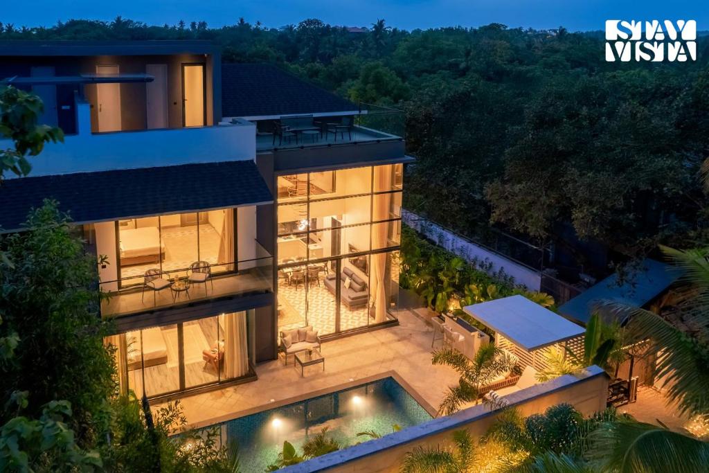 an aerial view of a house with a swimming pool at CASA JOE by StayVista luxurious 3BHK villa with Pvt Pool, Bathtub & Complimentary E-bikes in Vagator
