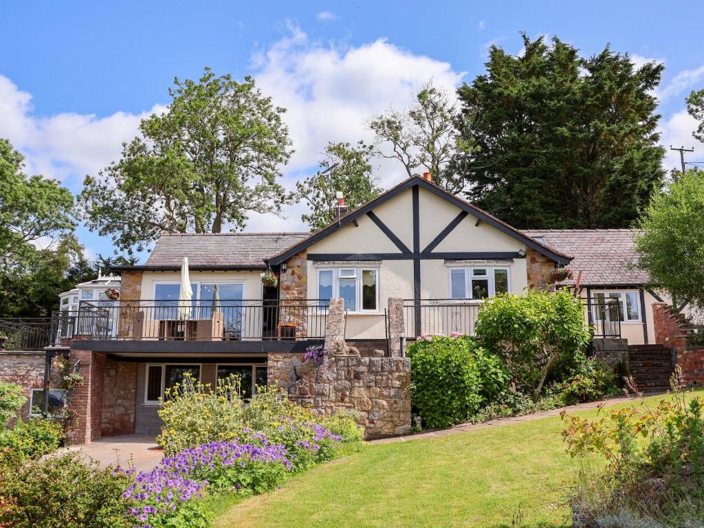 an exterior view of a house with a garden at The Old Barn in Ruthin