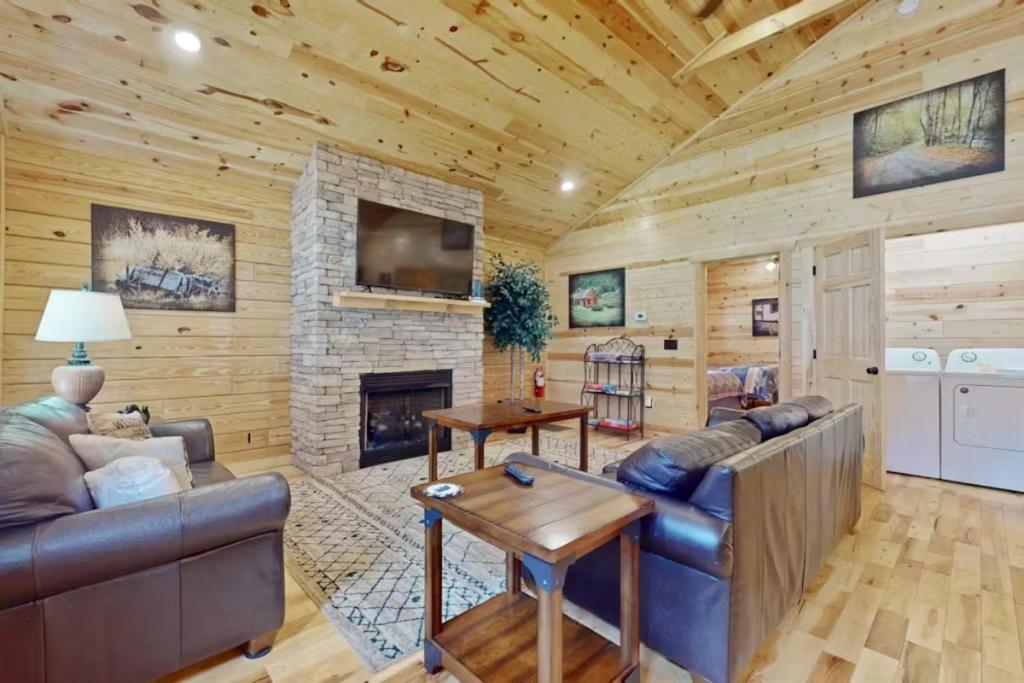 a living room with a couch and a fireplace at Southern Comfort Cabin By Avada Properties in Gatlinburg