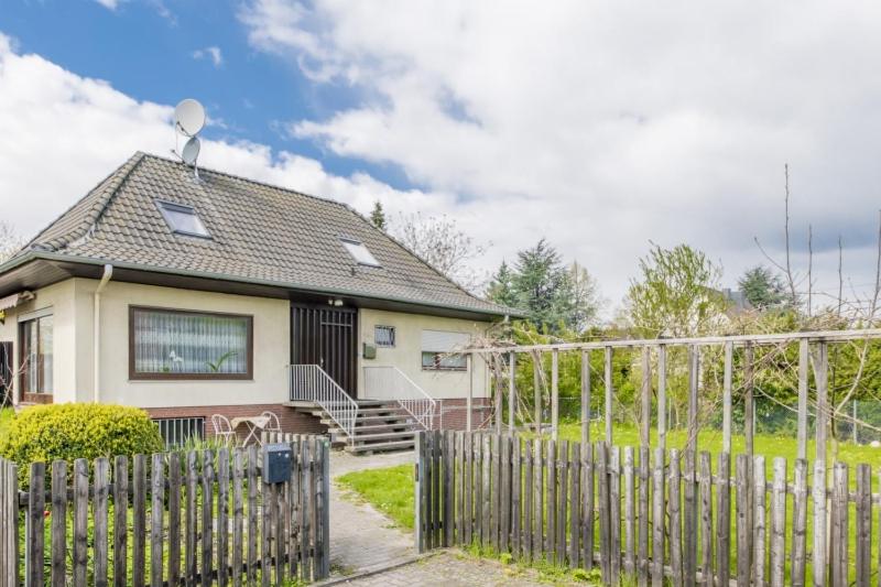 a house with a wooden fence in front of it at Private Rooms in Hannover