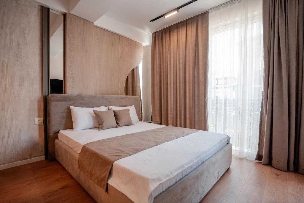 a bedroom with a large bed and a large window at Luxury Apartments Stefano - Prestige in Ohrid