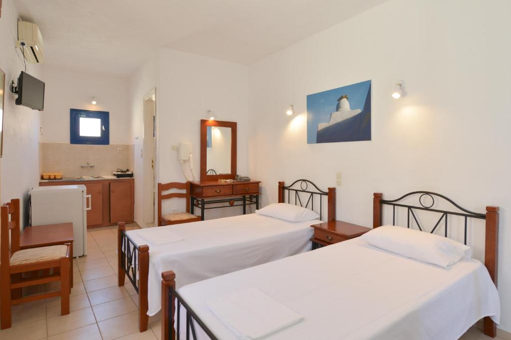Postel nebo postele na pokoji v ubytování Windmill Villas