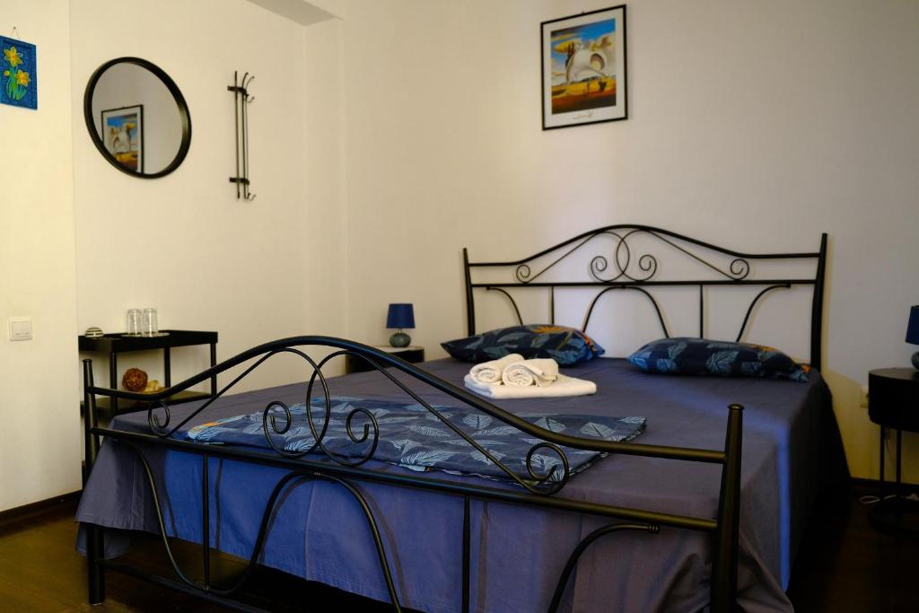 a bedroom with a bed with a metal frame at Vila Iulia in Eforie Nord