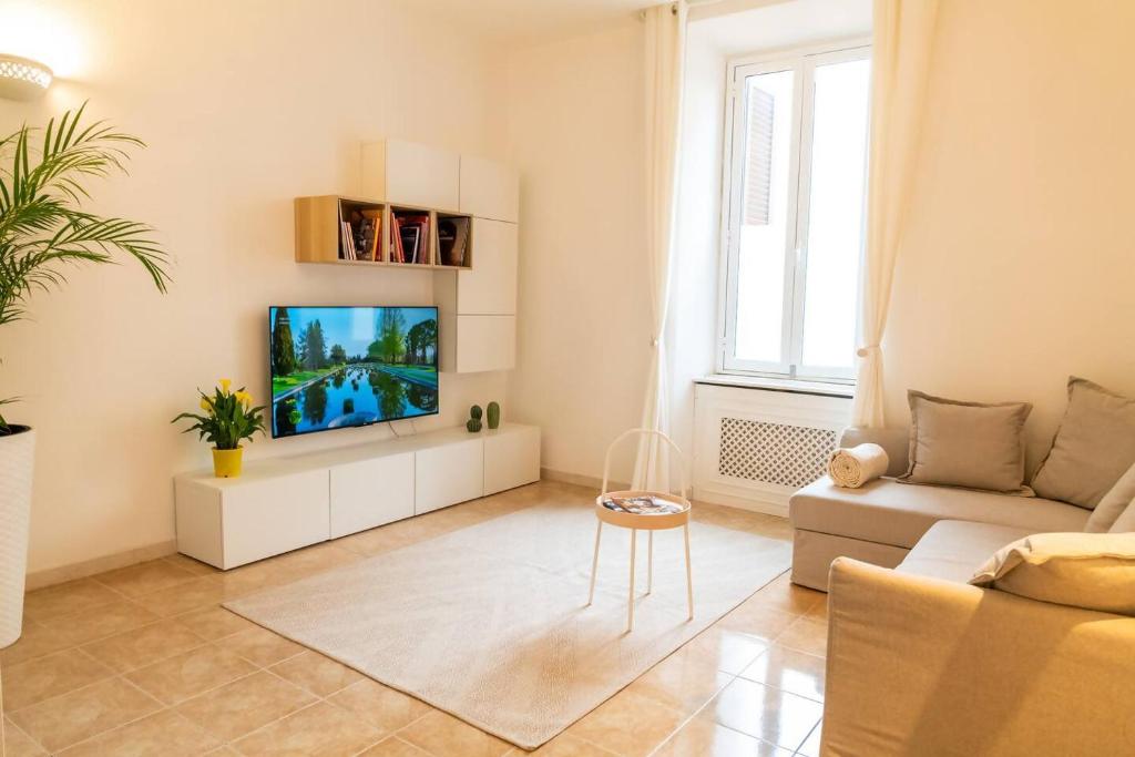 a living room with a couch and a tv at Music & Art Holiday House in Lido di Ostia