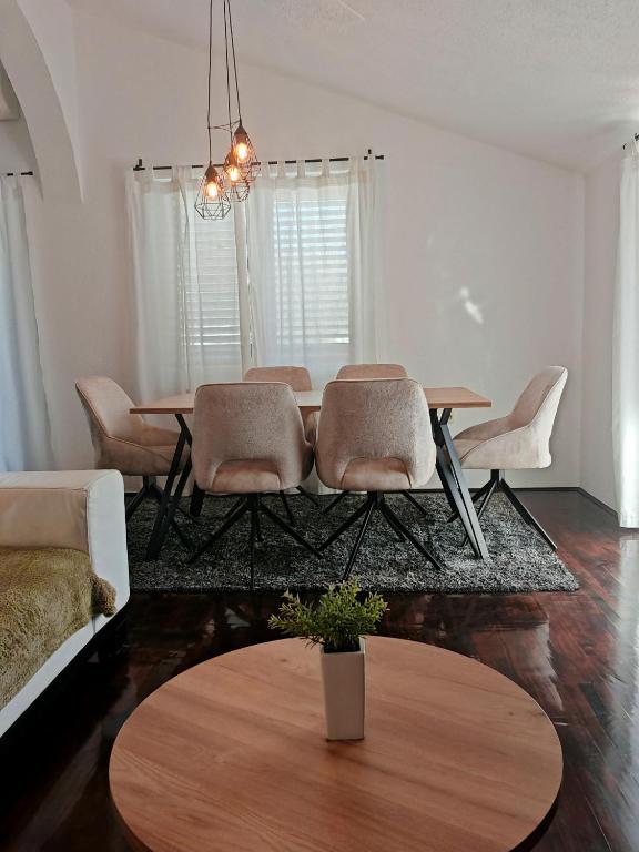 a living room with a table and chairs at Lifestyle apartment Podstrana in Podstrana