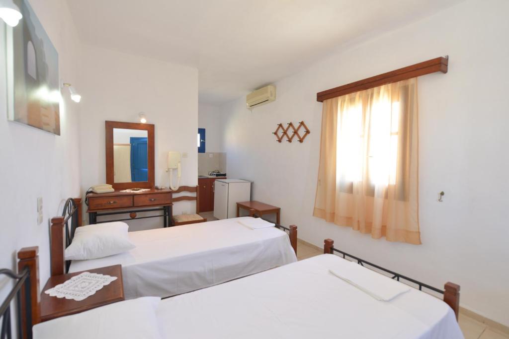 Postel nebo postele na pokoji v ubytování Windmill Villas