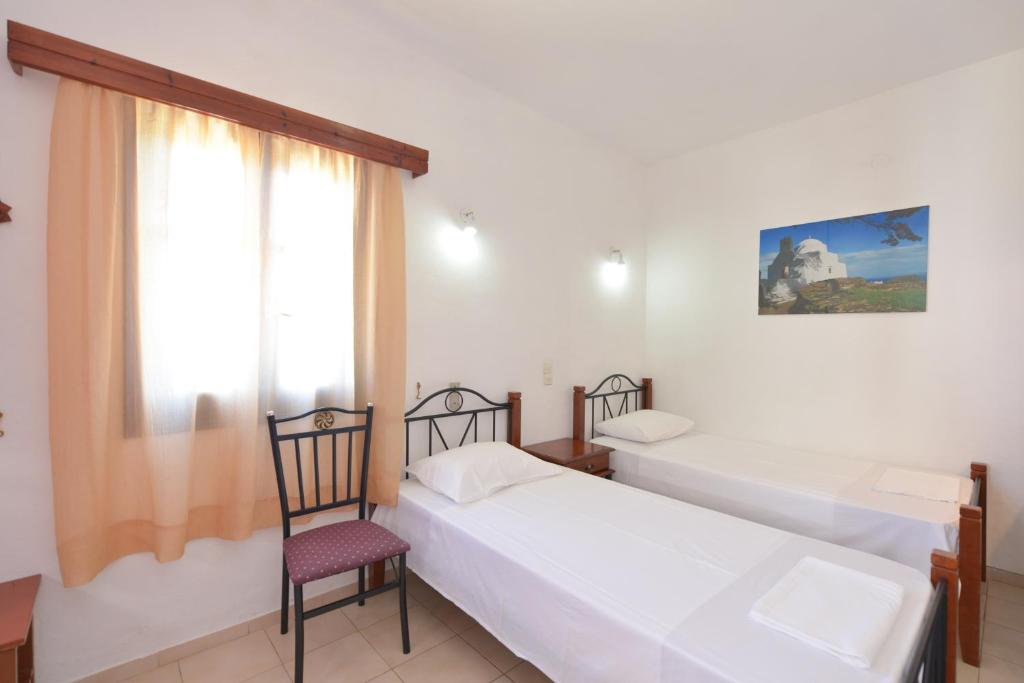 Postel nebo postele na pokoji v ubytování Windmill Villas