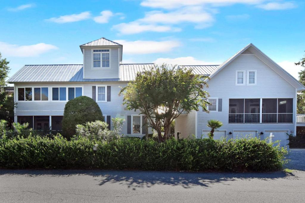 a white house with a gambrel roof at 219 Olive Way in East End