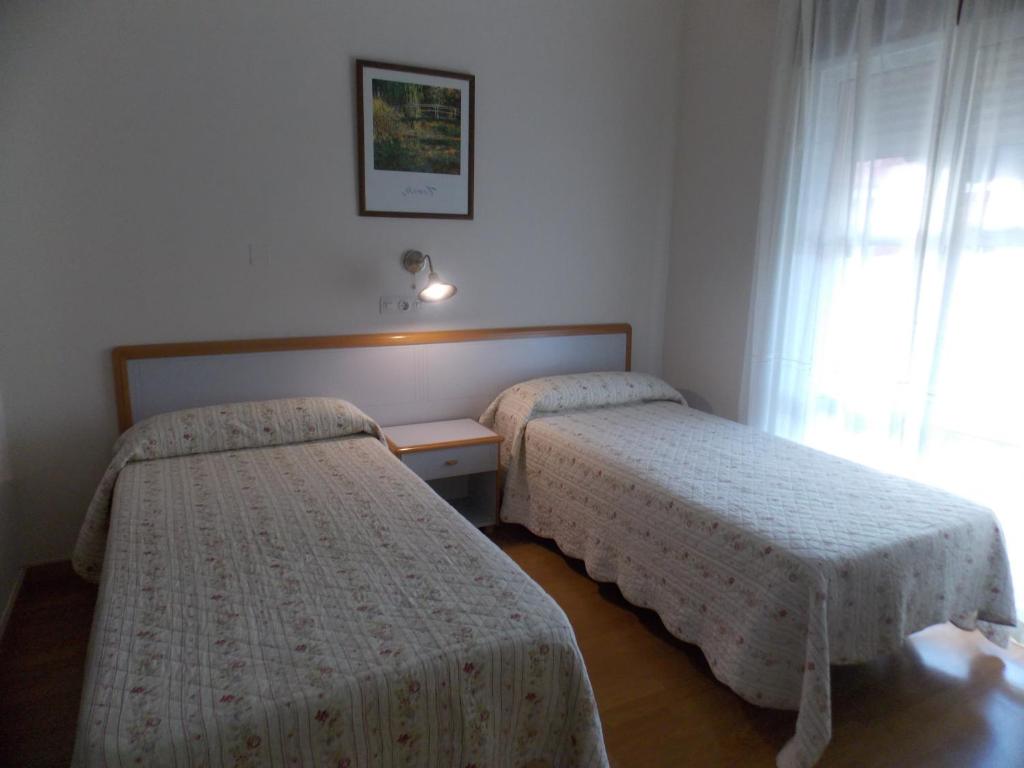 Postel nebo postele na pokoji v ubytování Pensión La Palma