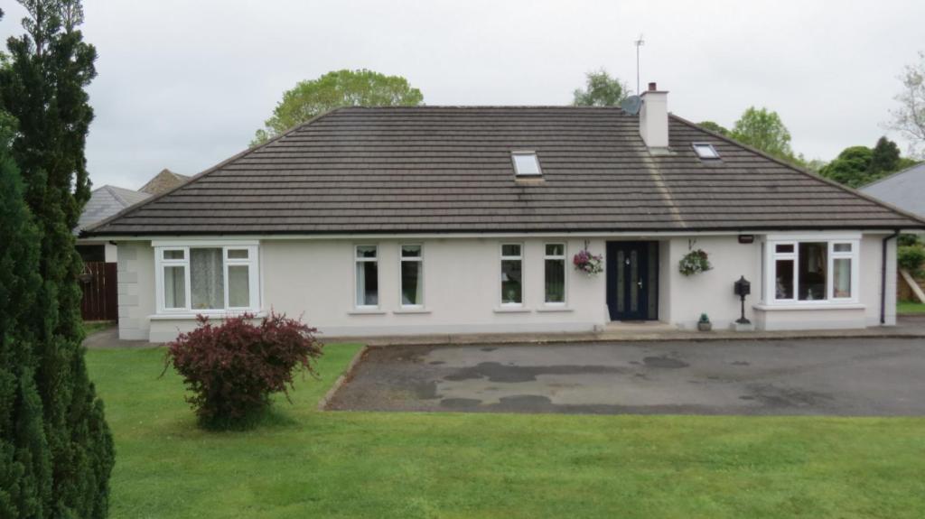 a white house with a black roof at Athgarvan B&B in Newbridge