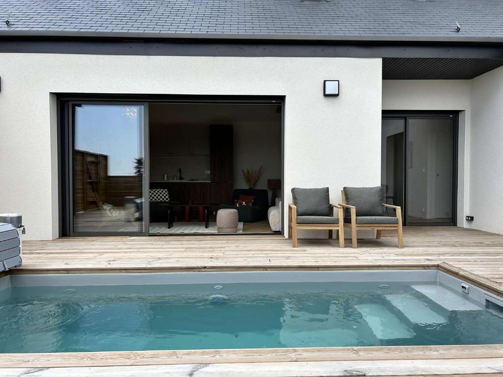 a swimming pool in front of a house at 766 - Maison moderne avec piscine privative. in Erquy