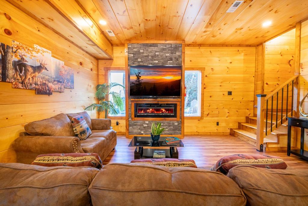 a living room with a couch and a fireplace at Three Little Bears 2 By Avada Properties in Gatlinburg