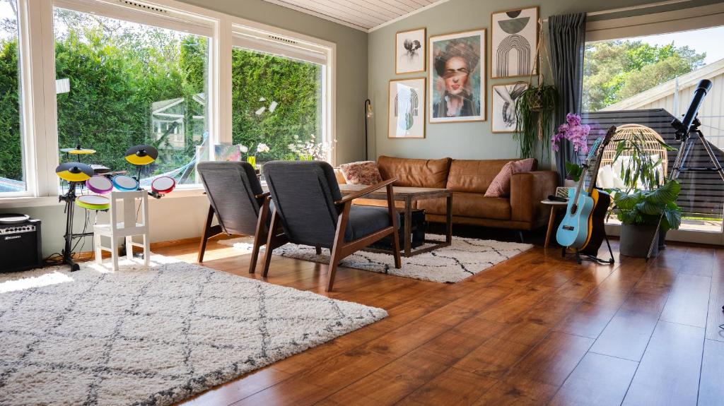 a living room with a couch and a table at Sunny, Family-Friendly Near Zoo & Local Beaches in Kristiansand