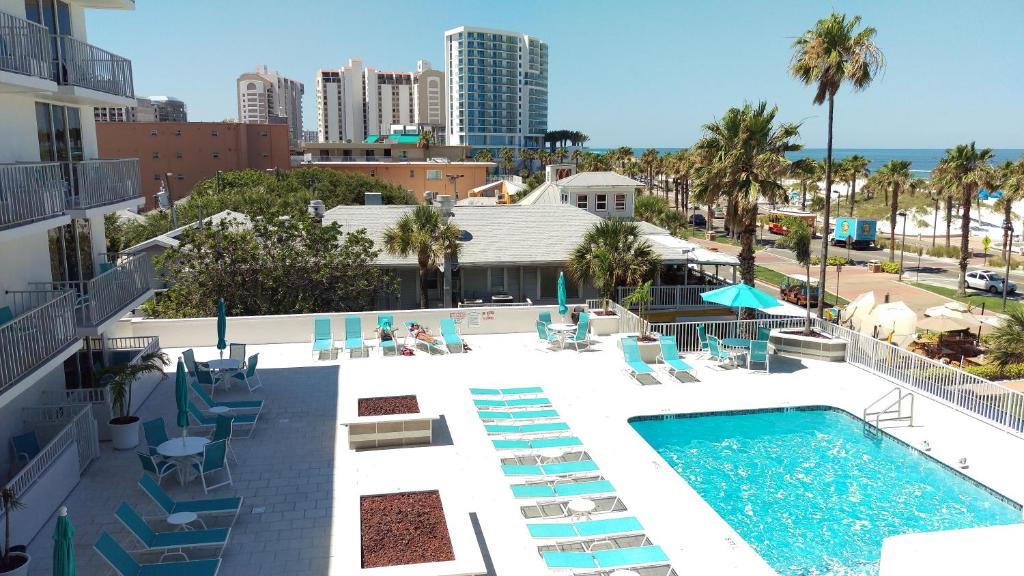 a swimming pool with lounge chairs and a resort at The Beachview Inn Clearwater Beach in Clearwater Beach