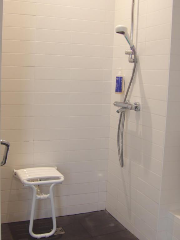 a shower in a bathroom with a toilet at Hôtel De La Vallée in Dinard