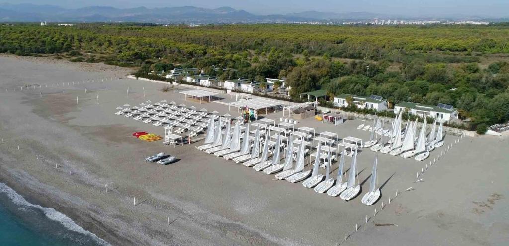 an aerial view of a beach with white umbrellas at Aquarius Policoro in Policoro