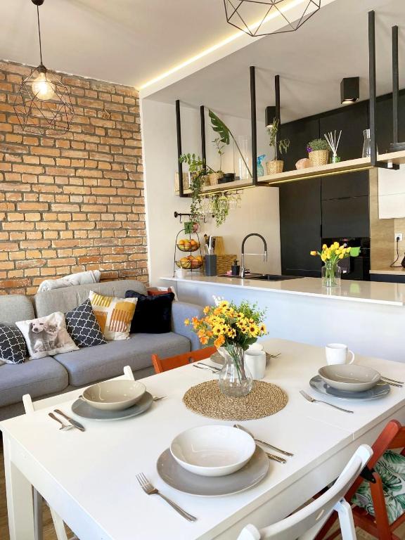a kitchen and living room with a white table and chairs at 67-Ratusz - DeerRest Apart in Jelenia Góra