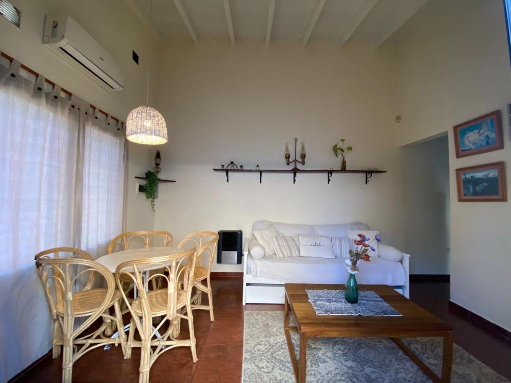 a living room with a couch and a table and chairs at Buen Descanso I in San Pedro