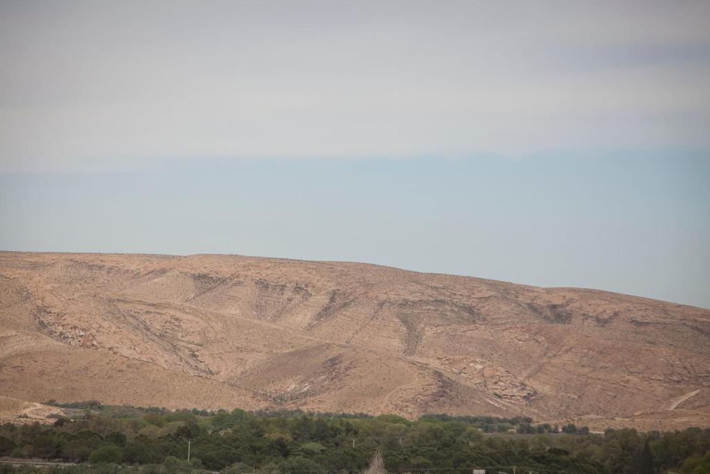 a large hill with trees in front of a mountain at Desert View in Yeroẖam