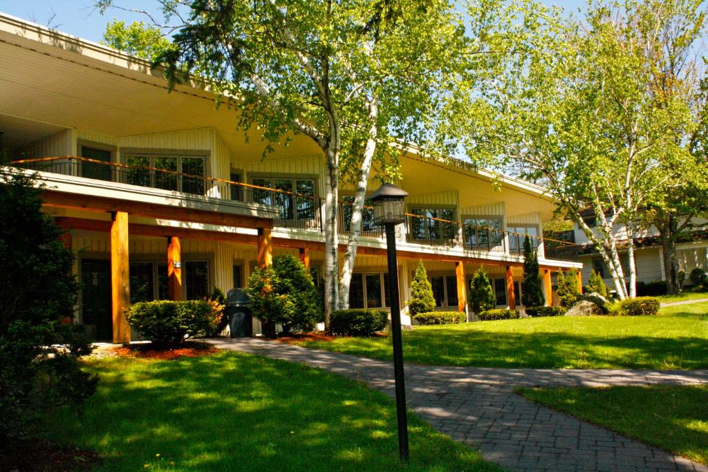 a yellow building with a walkway in front of it at Winwood Condominiums by Windham Mountain Club in Windham