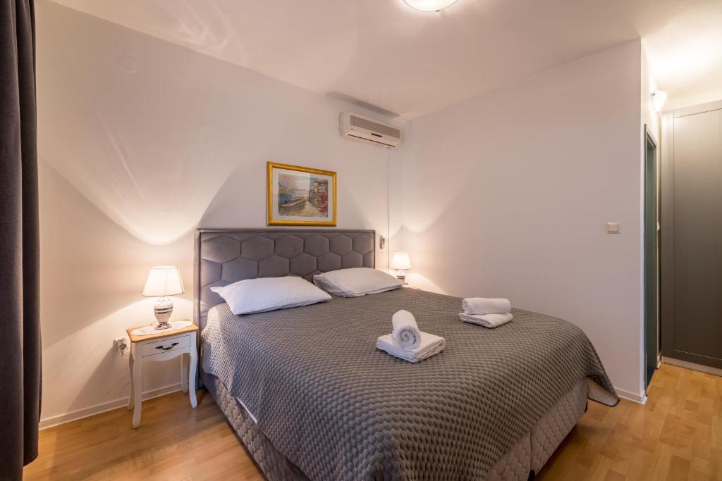 a bedroom with a bed with two towels on it at Guesthouse Rooms Split in Split