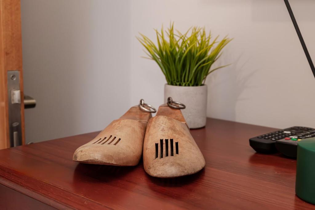 three pairs of shoes sitting on top of a desk at Casa Borda da Rocha in Nordeste
