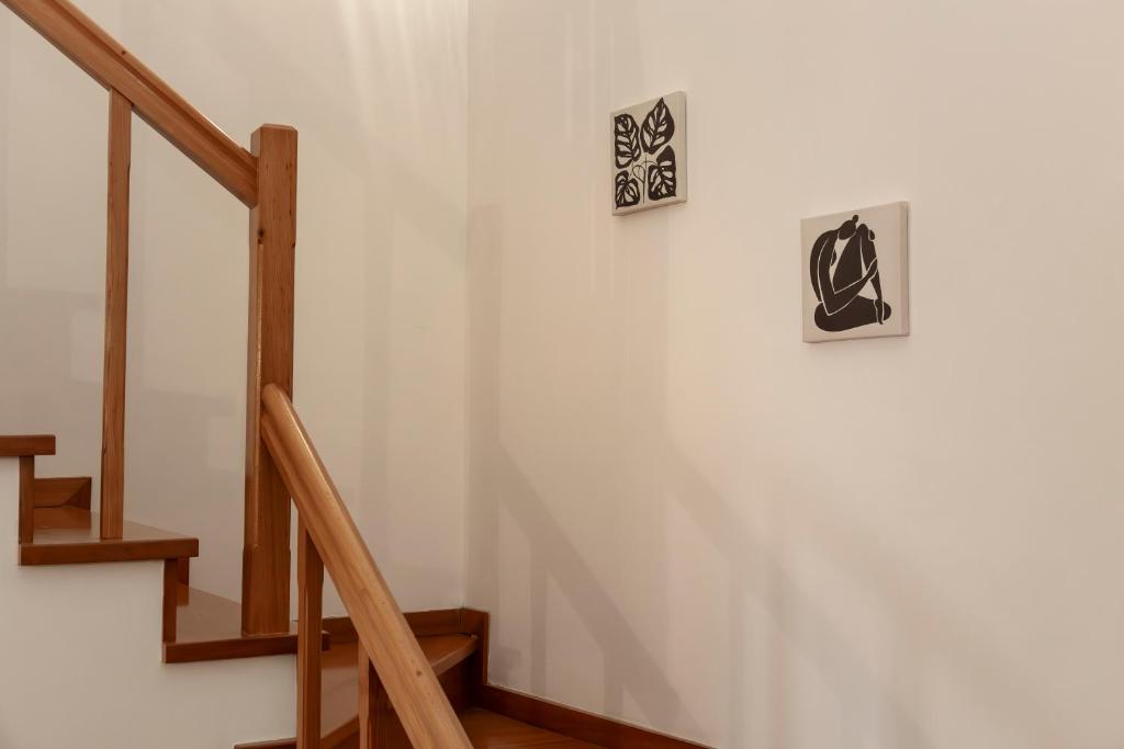 a stairway with two pictures on the wall at Casa Borda da Rocha in Nordeste